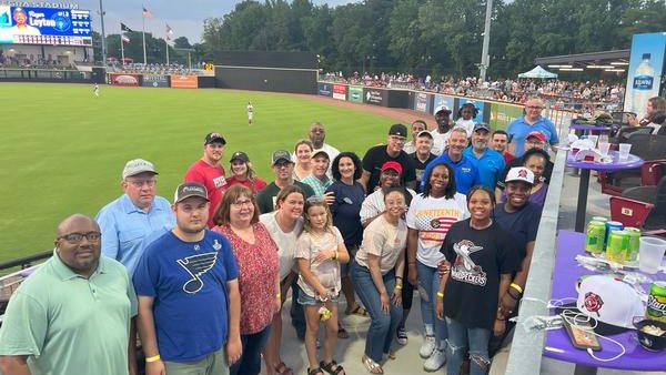 Chapter members and their families gathered on the field at a Fayetteville Woodpeckers game